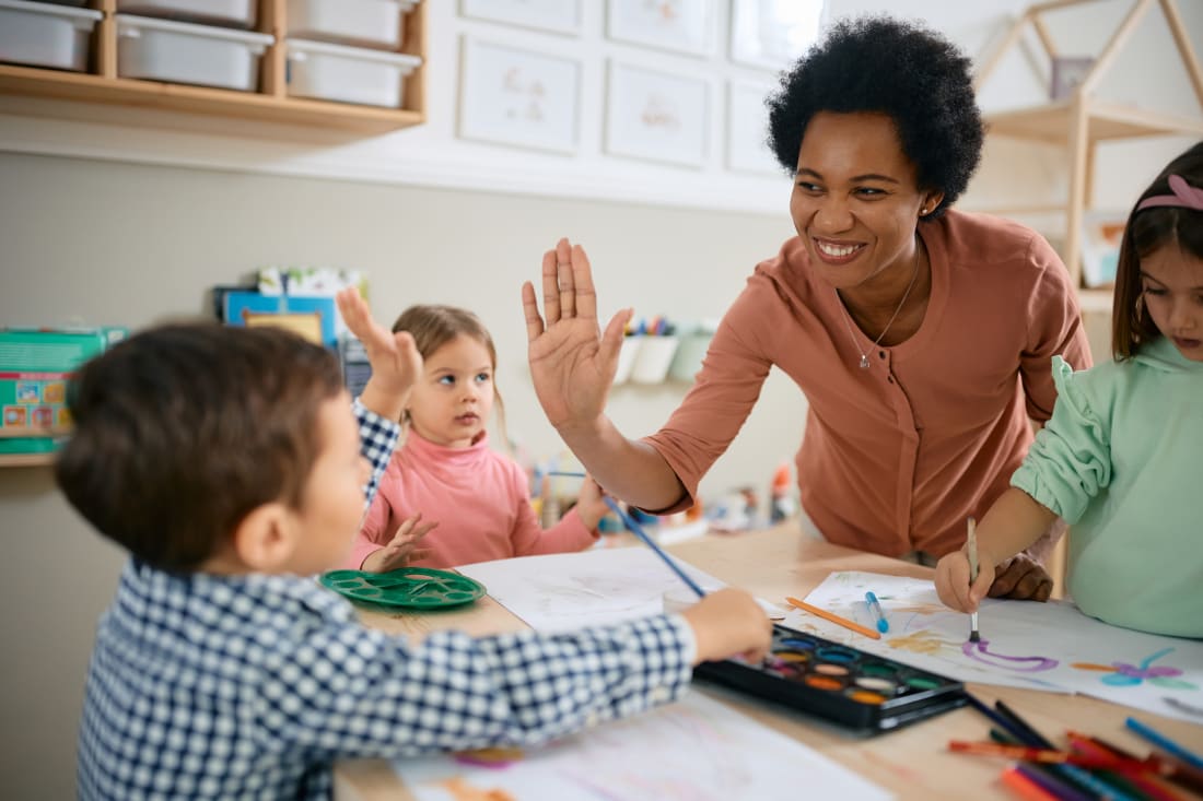Teacher giving a student a high-five 