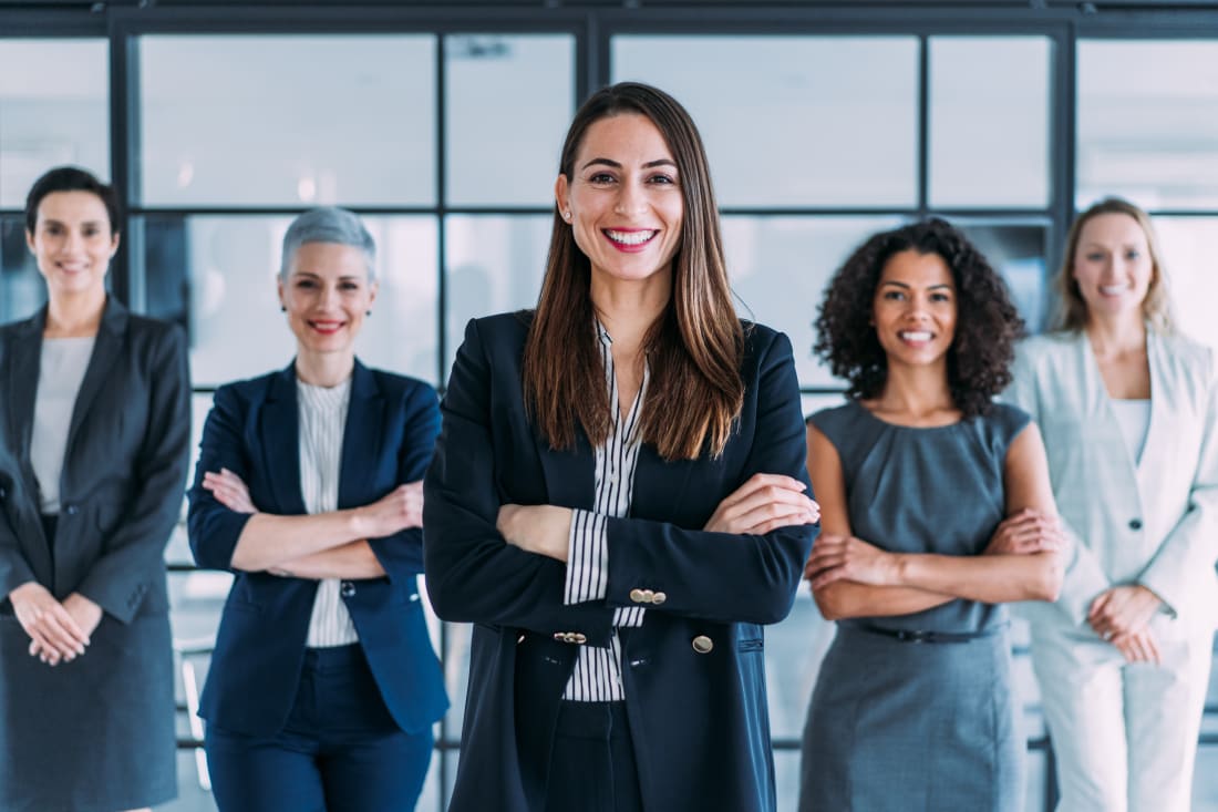 A group of businesswomen standing together in office.