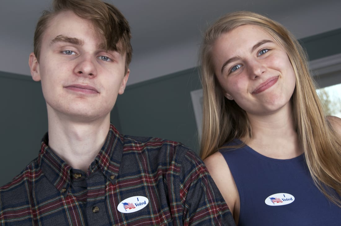 Teen male and femail with stickers I voted on smiling