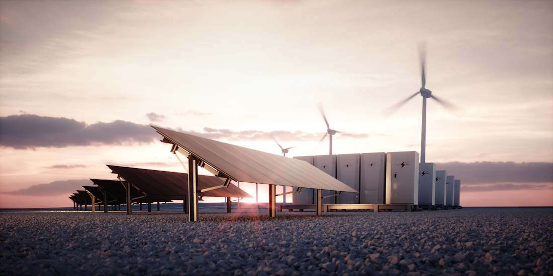 Solar panels and wind turbines in a gravel field collecting energy.