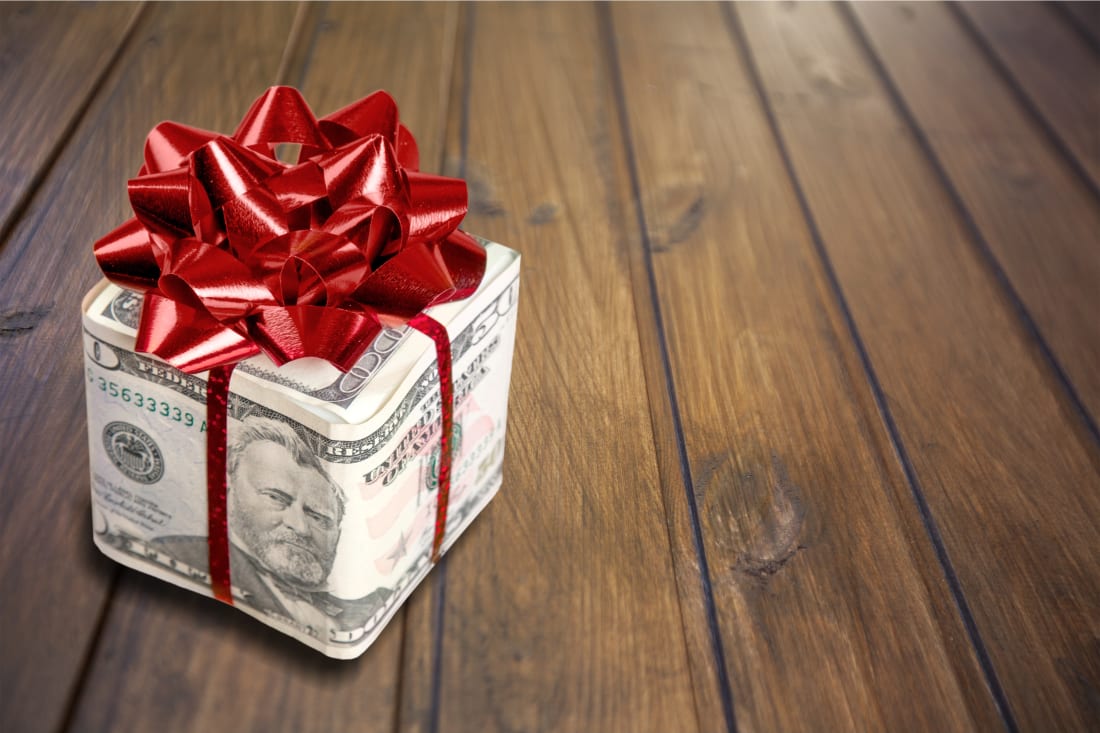 gift wrapper in forms of money with bow atop