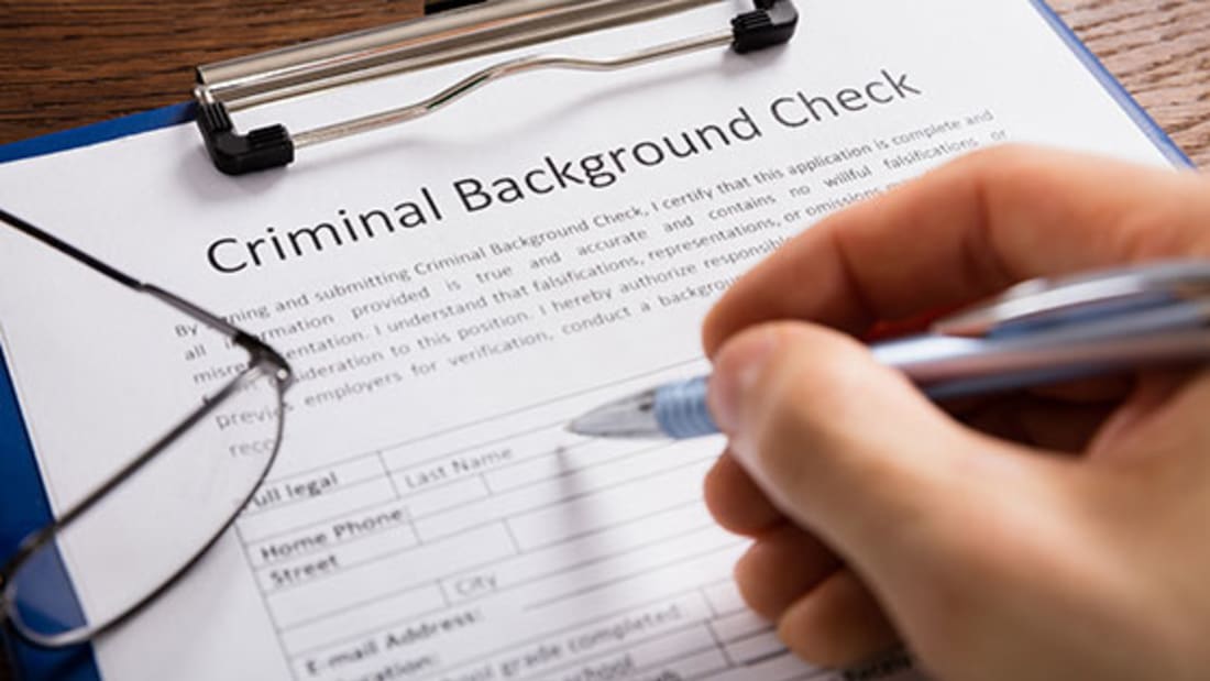 person completing a criminal background check form