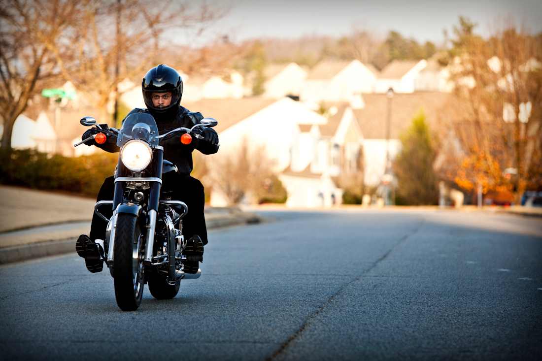 man riding motorcycle wearing helmet