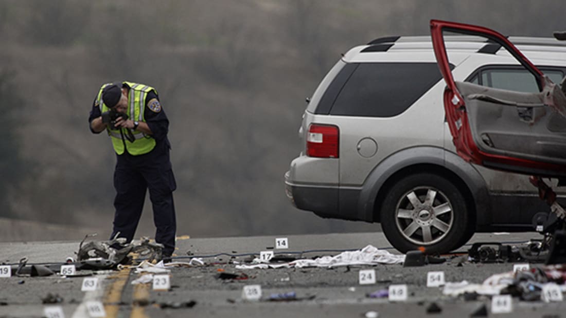Police officer taking photographs of a car accident