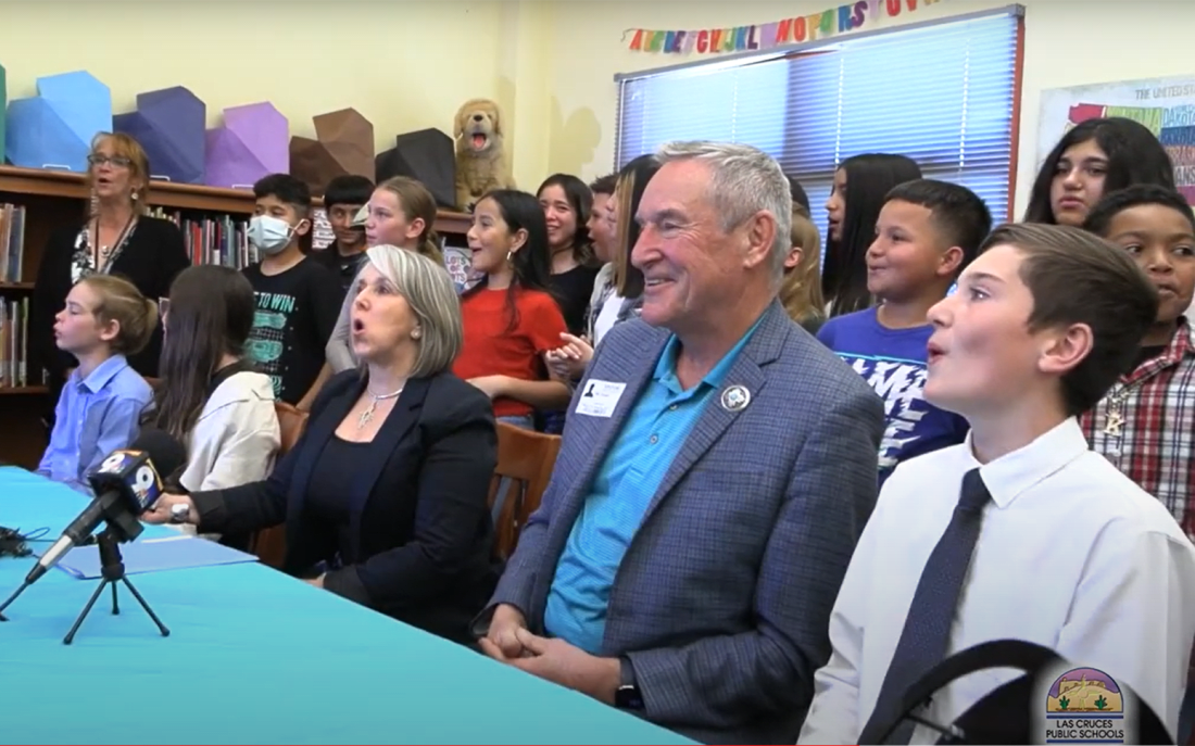 New Mexico Gov. Michelle Lujan Grisham does the Wolf Pack howl with the fifth graders of Monte Vista Elementary, who led the way in passing a law to make green chiles roasting the official state aroma; she was joined by state Sen. Bill Soules