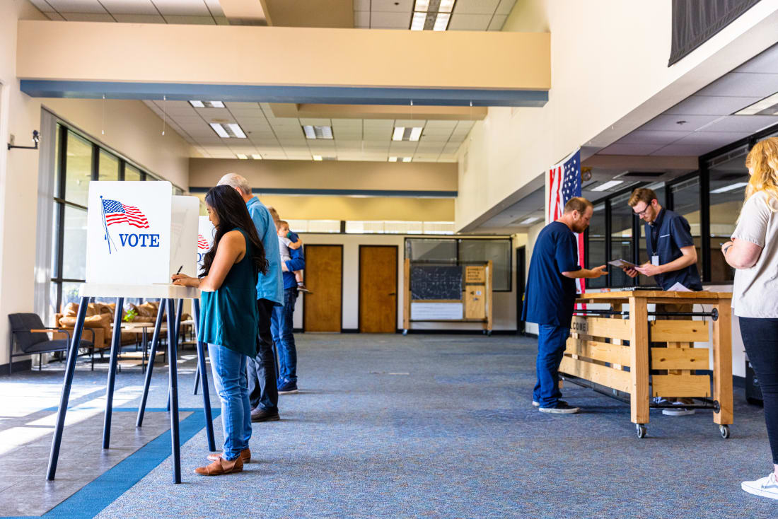 voters casting ballots at polling station