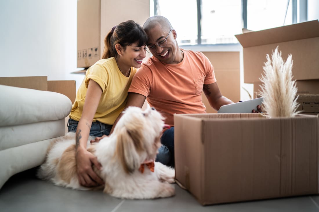 image showing young home buyers unpacking boxes in new house