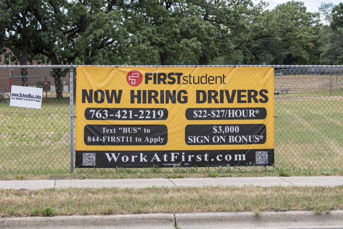 now hiring signs with pay rate advertised