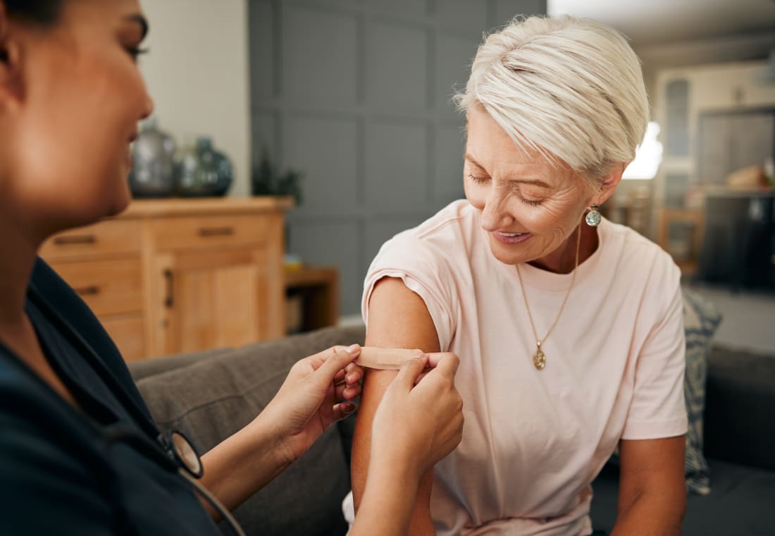 older adult woman receiving vaccine shot