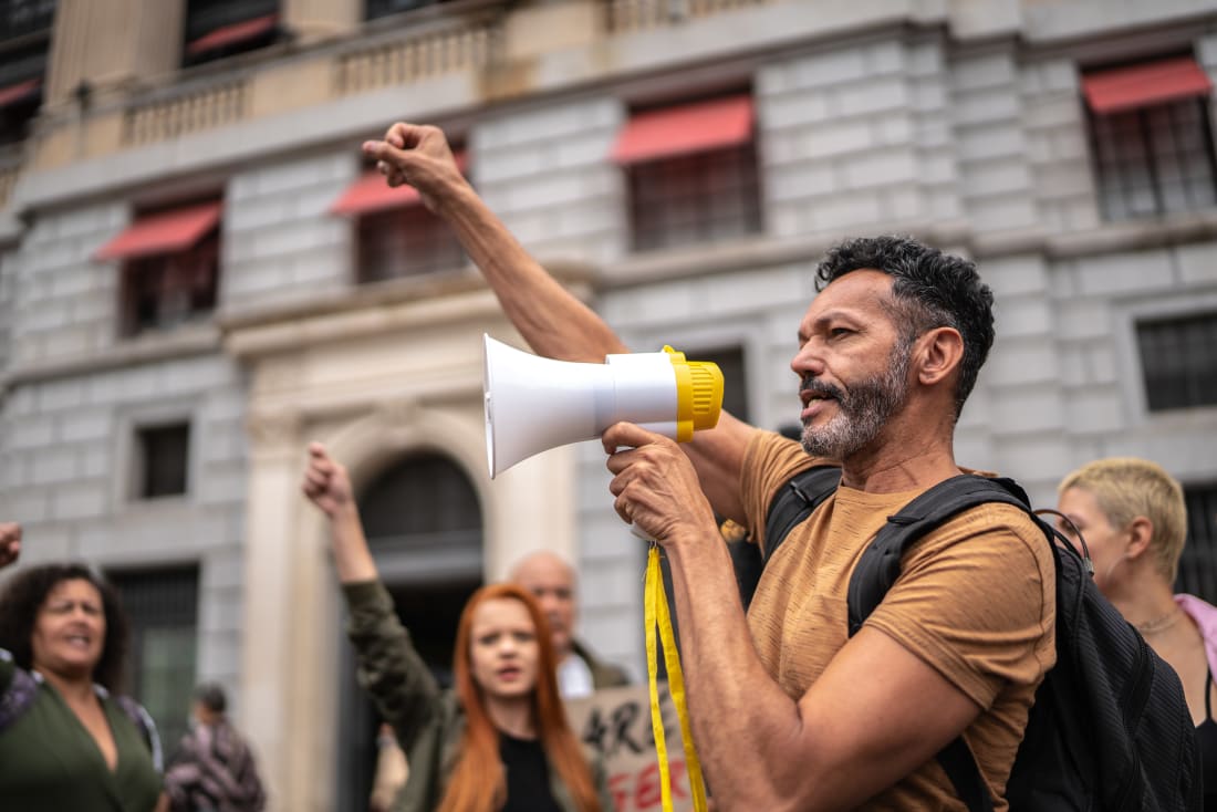man with bullhorn at demonstration