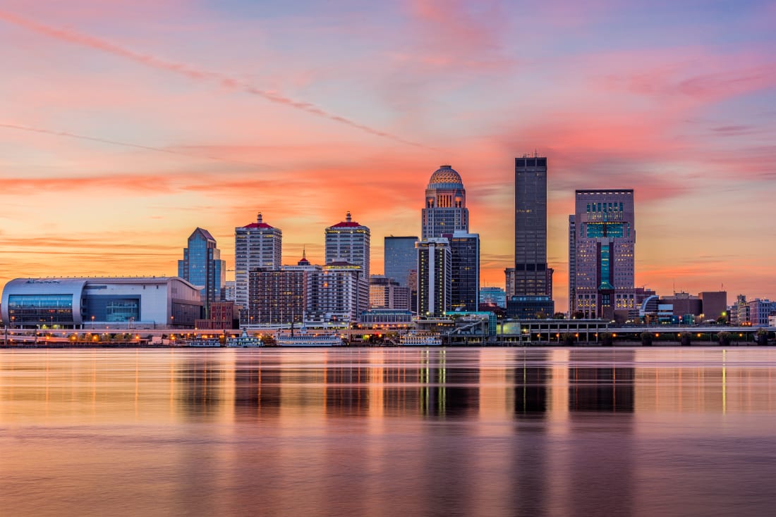 view from the Ohio River of the Louisville skyline at sunset