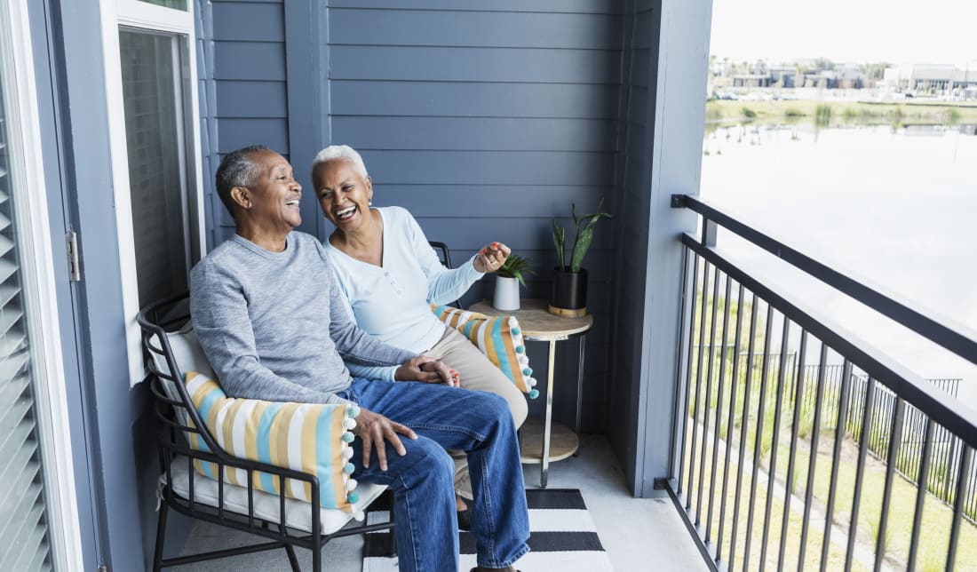 elderly couple sitting on porch at home