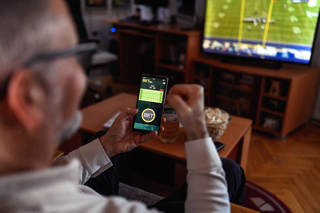 man sports betting on phone