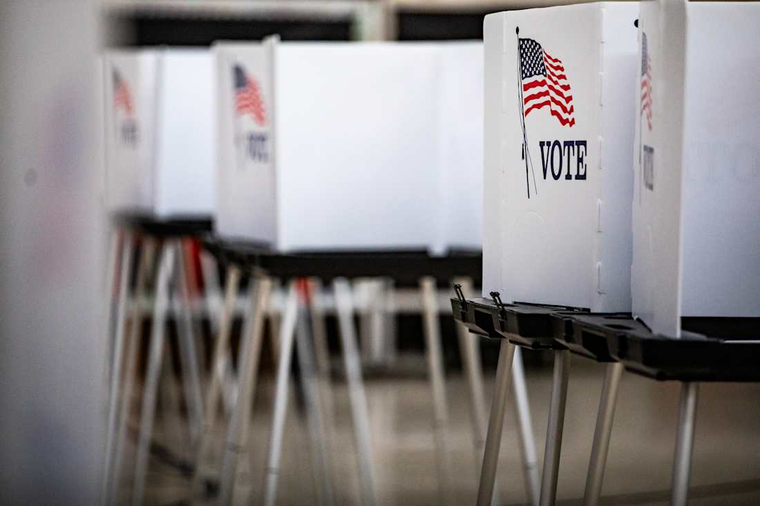 A row of standing voting booths.