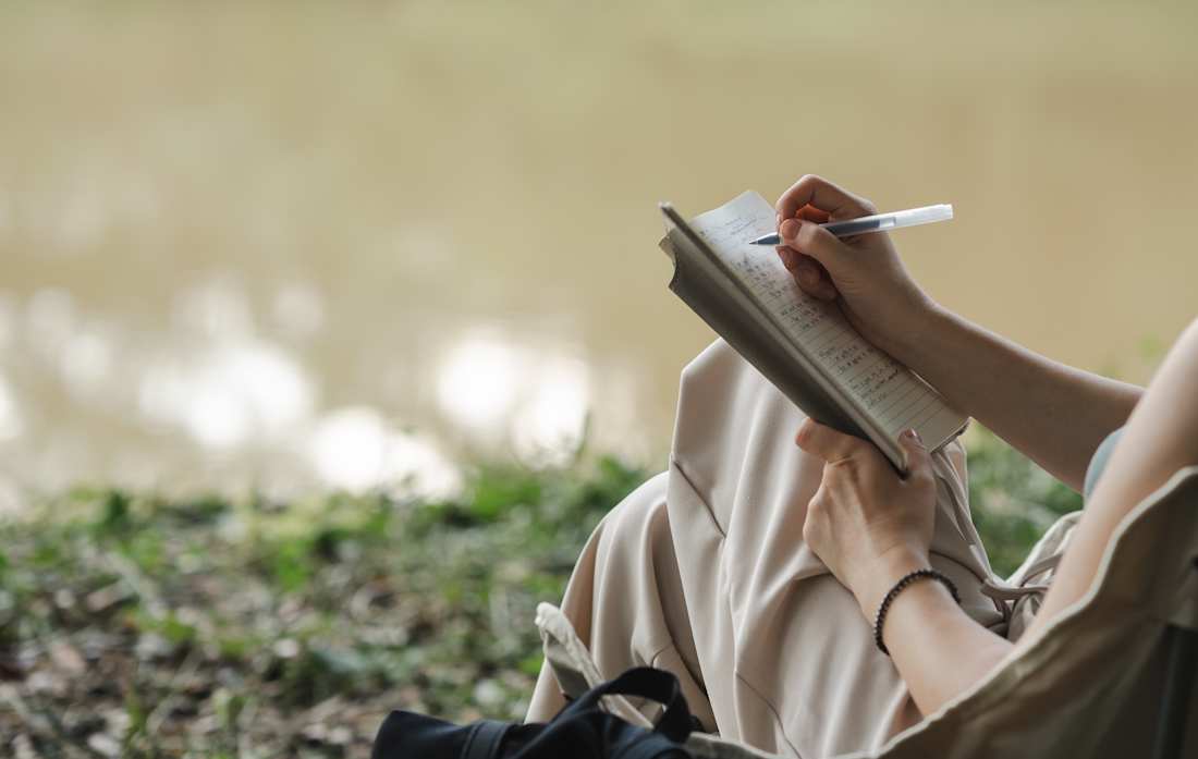 woman writing in tablet
