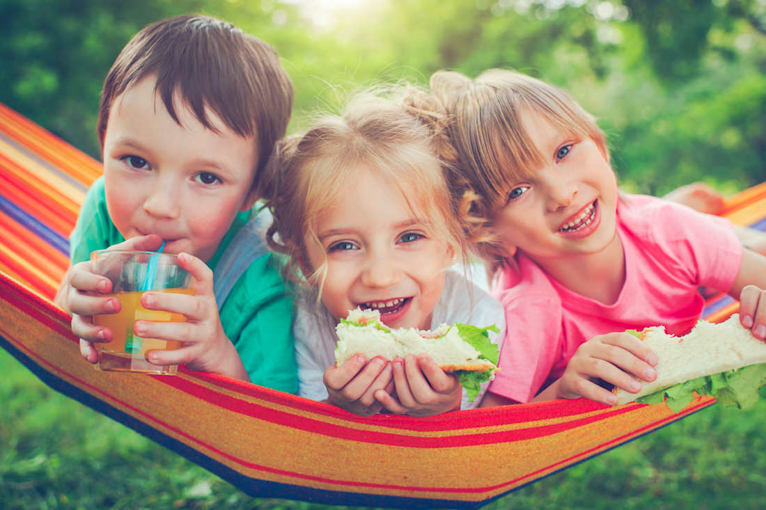 boy and two girls eating lunch