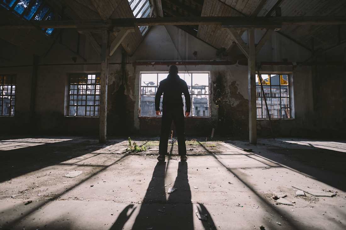 man standing alone inside building