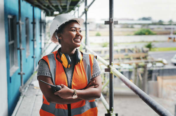 African American woman construction worker wearing vest and hardhat