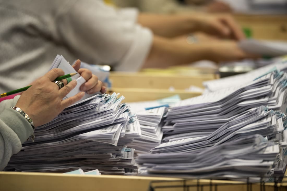 a close up of ballot papers being counted during an election