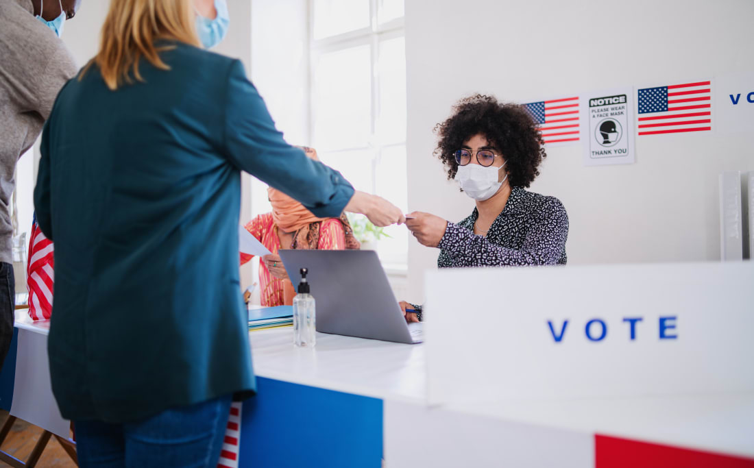 Group of people with face mask voting in polling place