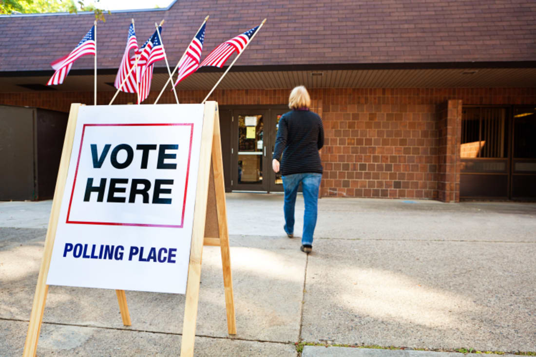 woman walking outside of polling place