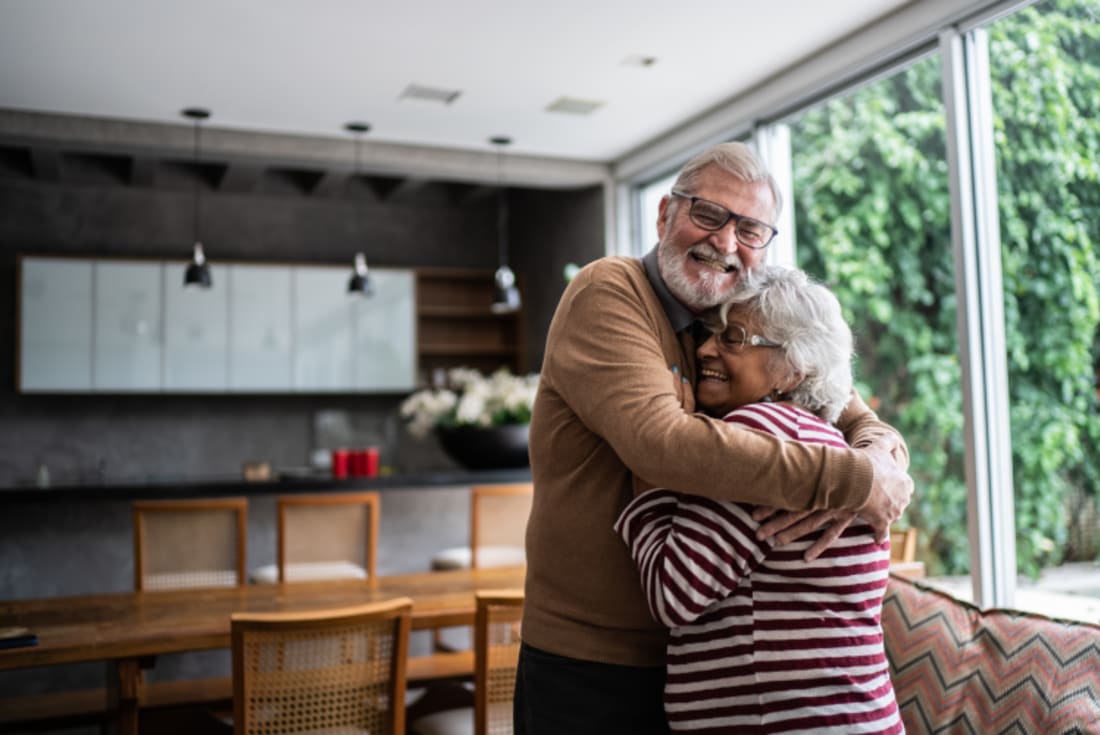 senior couple hugging at home