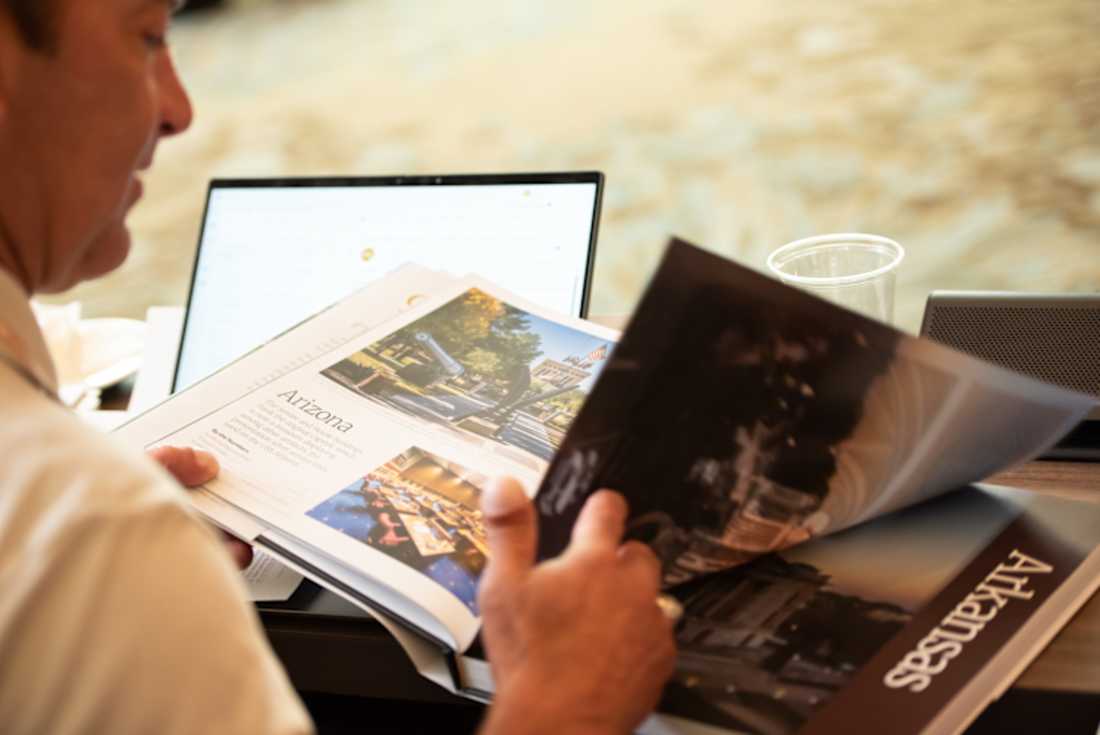 man reading "Capitol Views" book