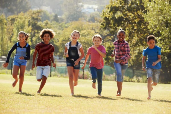 Six children of different races running outside
