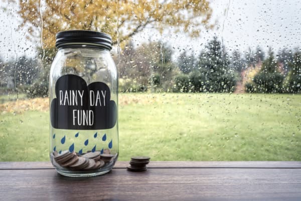 Savings for a rainy day fund glass jar with money