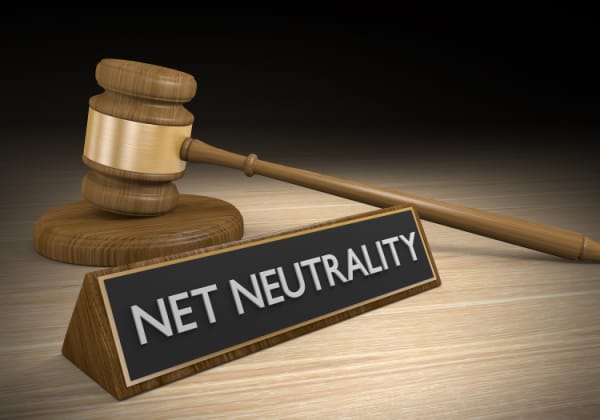 Wooden court gavel next to a sign that says net neutrality