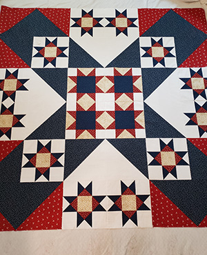 A square star quilt made by Brenda Erickson