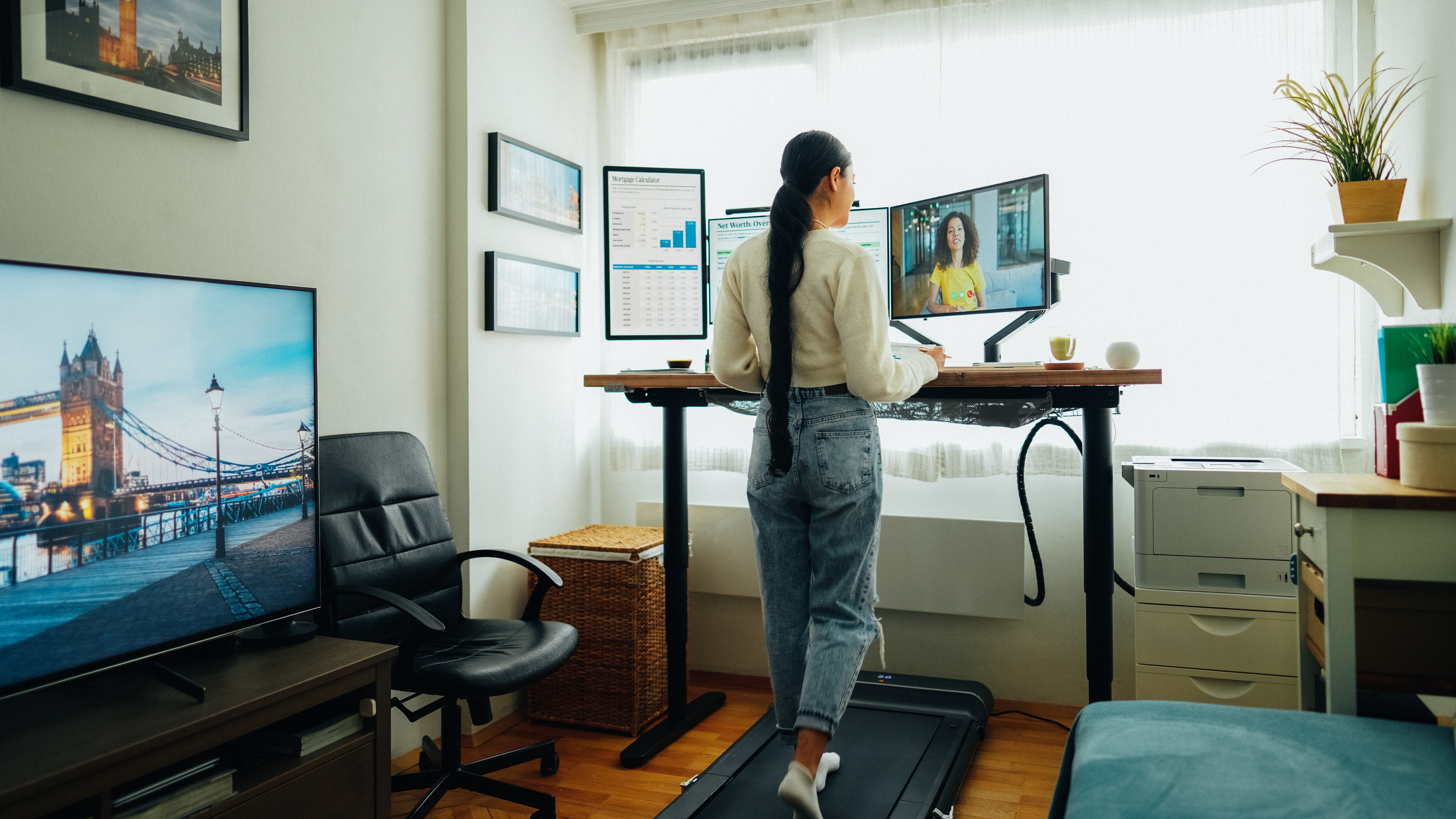 woman standing at desk on video call remote work